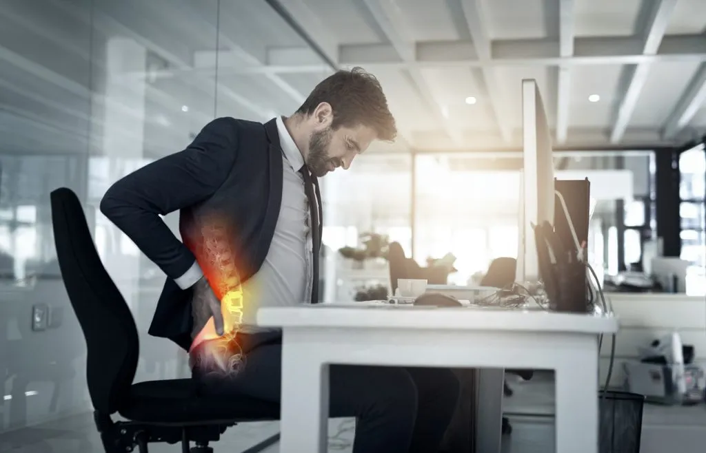 Employee with back pain at work